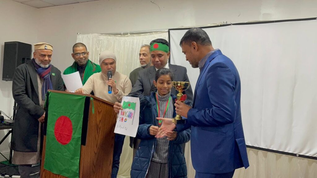 A community member speaks during the JPS Victory Day of Bangladesh celebration.