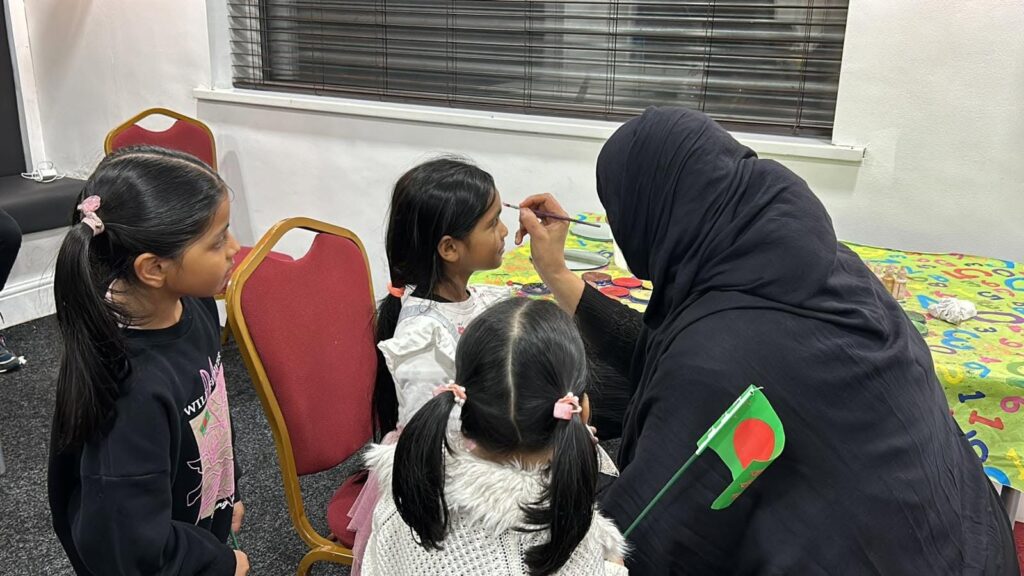 A child enjoying face painting during the JPS Victory Day community celebration.